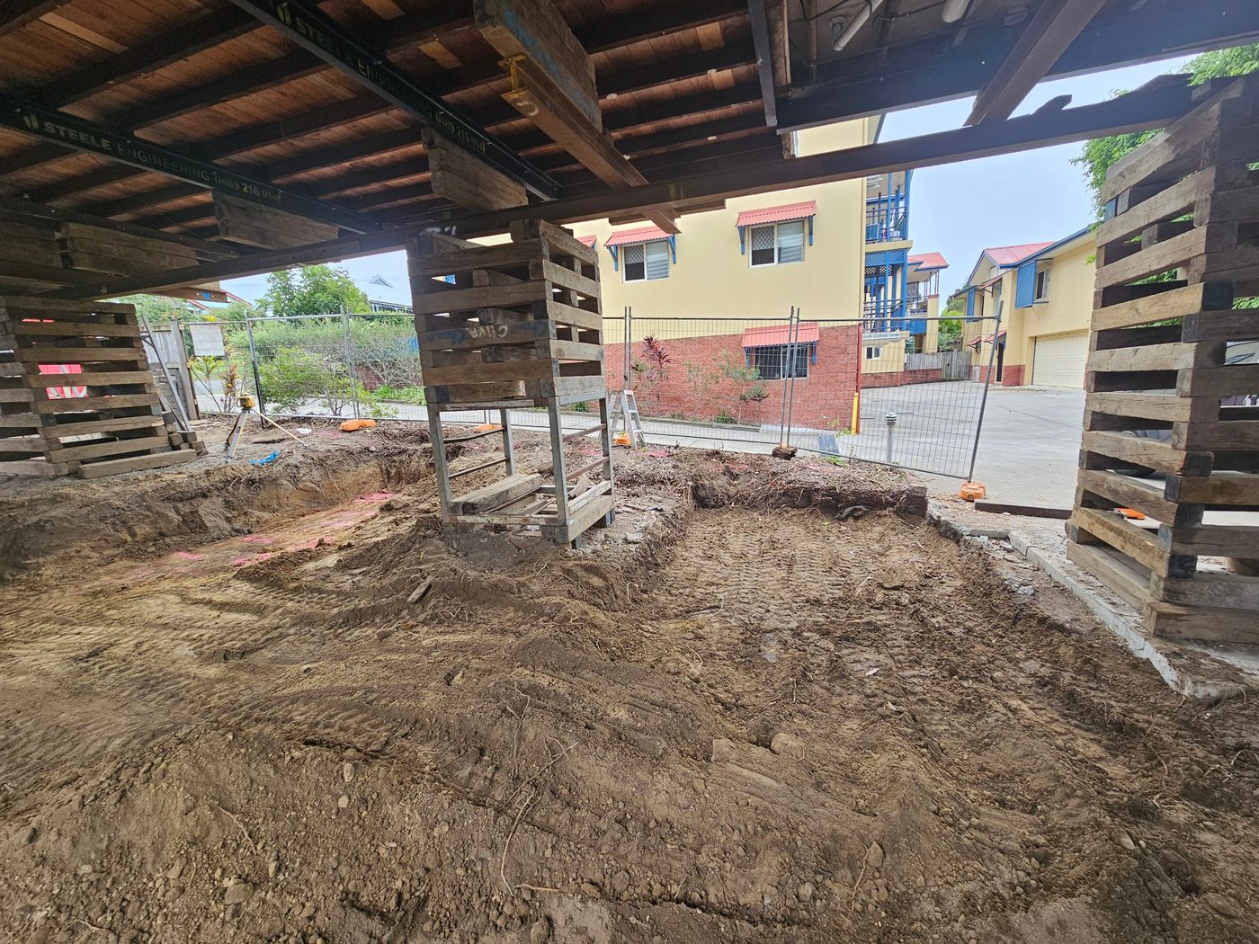 Under-house excavation with structural support in place